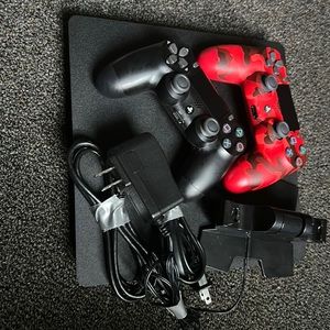 Used PlayStation 4, Additional red camo controller, and controller charging dock